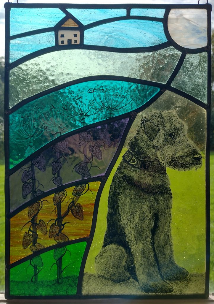 Airedale dog. Black lead paint on stained glass.